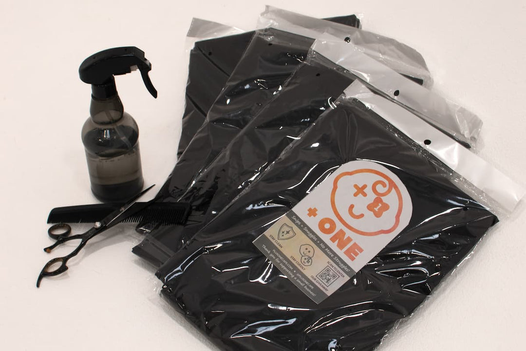 +ONE haircutting cape product packaging and barber tools